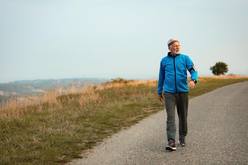 Elderly gentleman walking outdoors